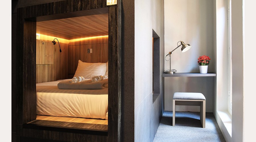 Capsules lining the long narrow depth of a converted shophouse floor - Cube Boutique Capsule Hotel Chinatown, Singapore